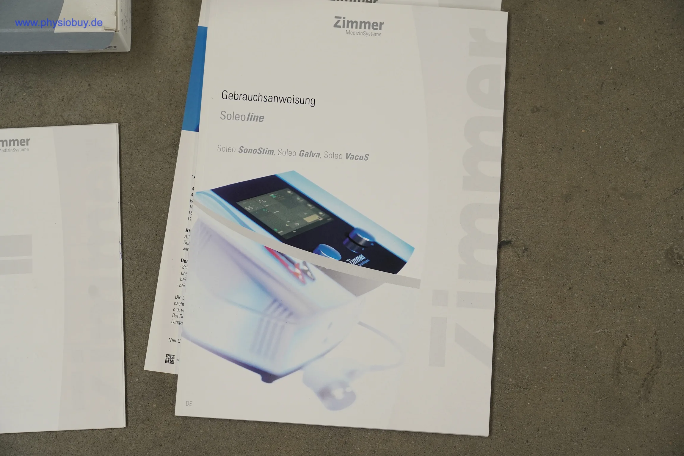 Zimmer Soleo SonoStim: Gebrauchsanweisung mit Gerätebild auf dem Cover, daneben weitere Unterlagen
